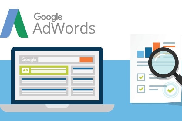 Digital Marketing Services 16 Laptop with Google Adwords on the Screen plus a Facebook Paid Search Report with a Magnifying Glass