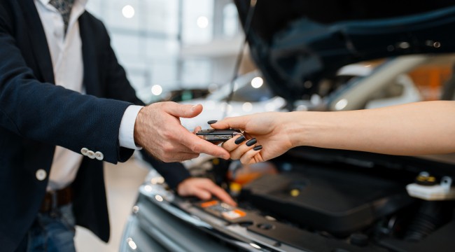 Car Dealer Owner Helping Customer