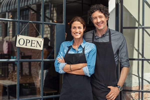 New Business Owners with Open Sign
